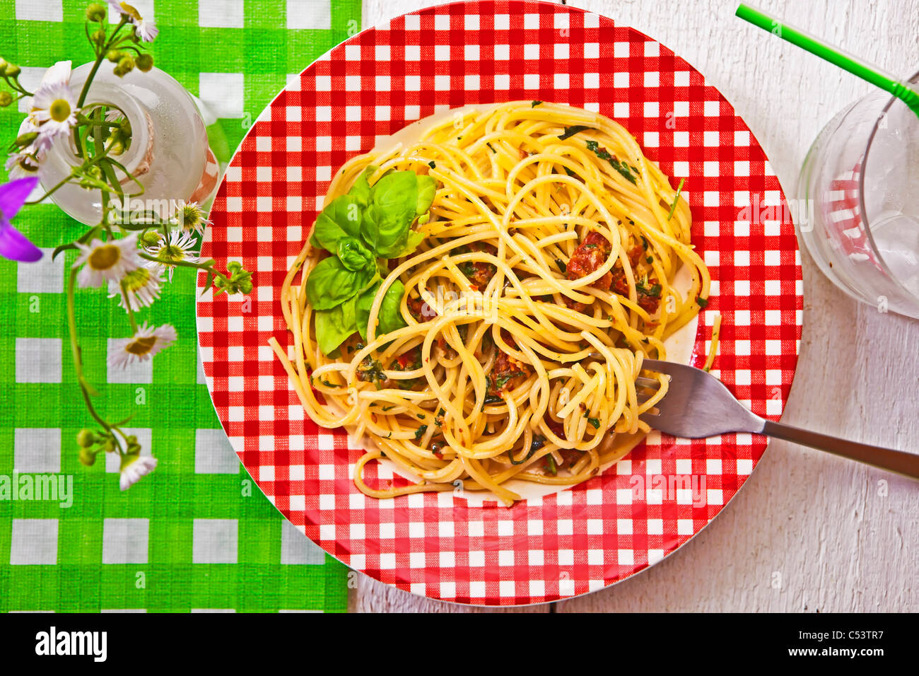 Spaghetti with pesto, made from dried tomatoes, Grana, pecorino, arugula, basil, pine nuts and garlic Stock Photo