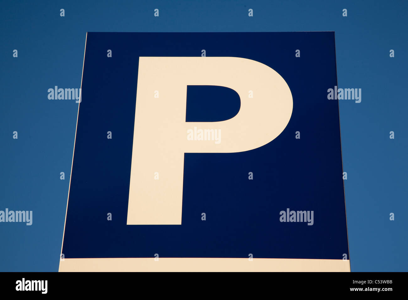 Close-up of parking sign against blue sky background Stock Photo - Alamy