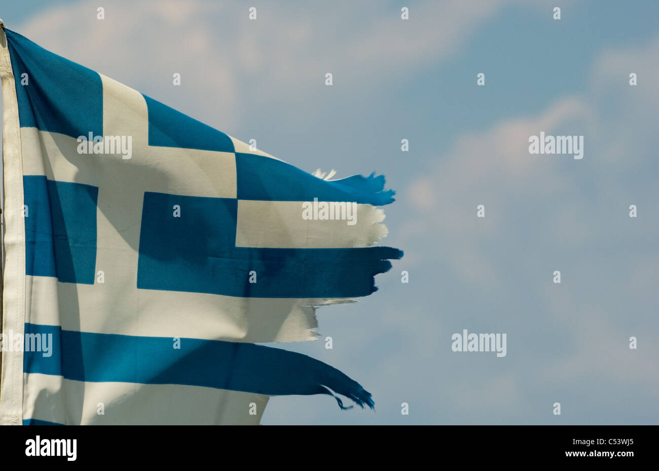 Greek austerity concept featuring a ragged, torn Greek flag. (Space for copy). Stock Photo
