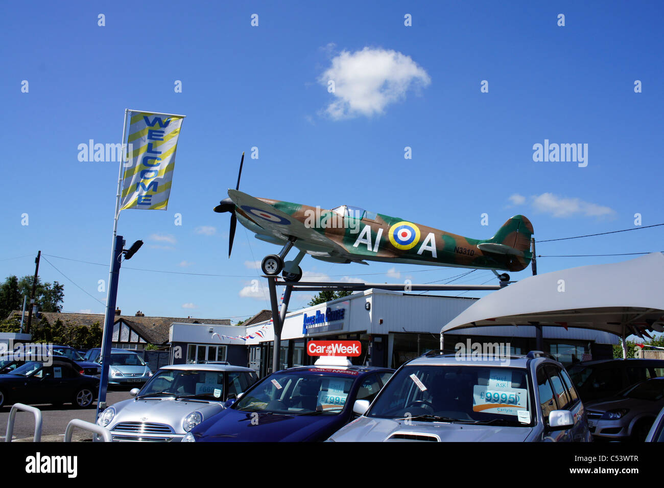 Spitfire aeroplane on top of car sales garage Stock Photo Alamy