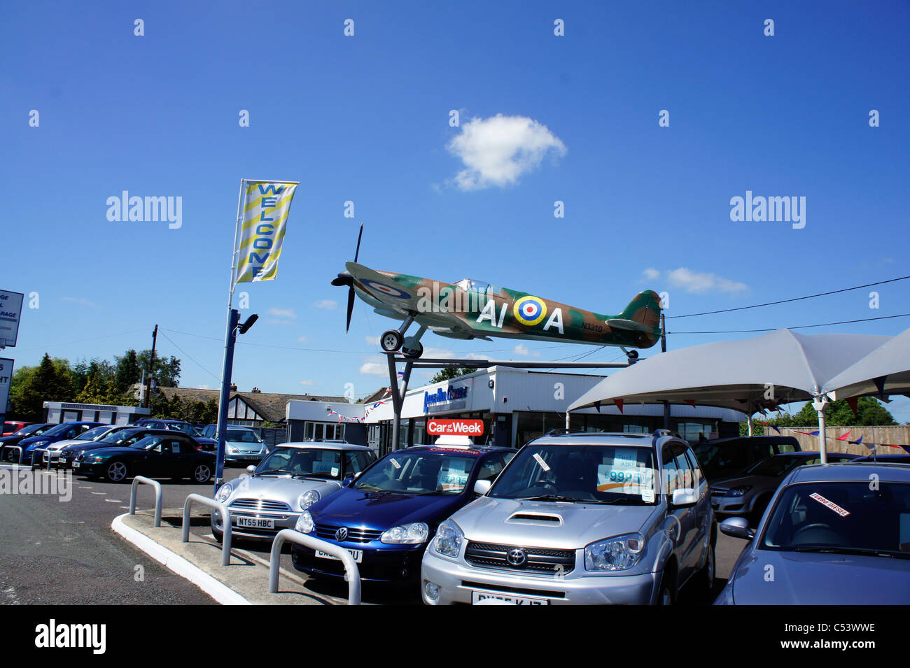 Spitfire aeroplane on top of car sales garage Stock Photo Alamy