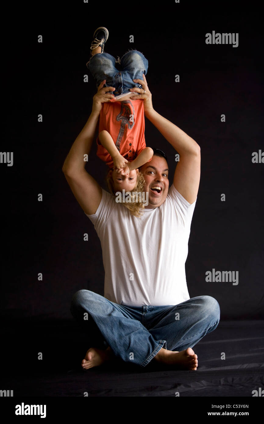 Father holding son upside down - Fort Lauderdale, Florida USA Stock Photo