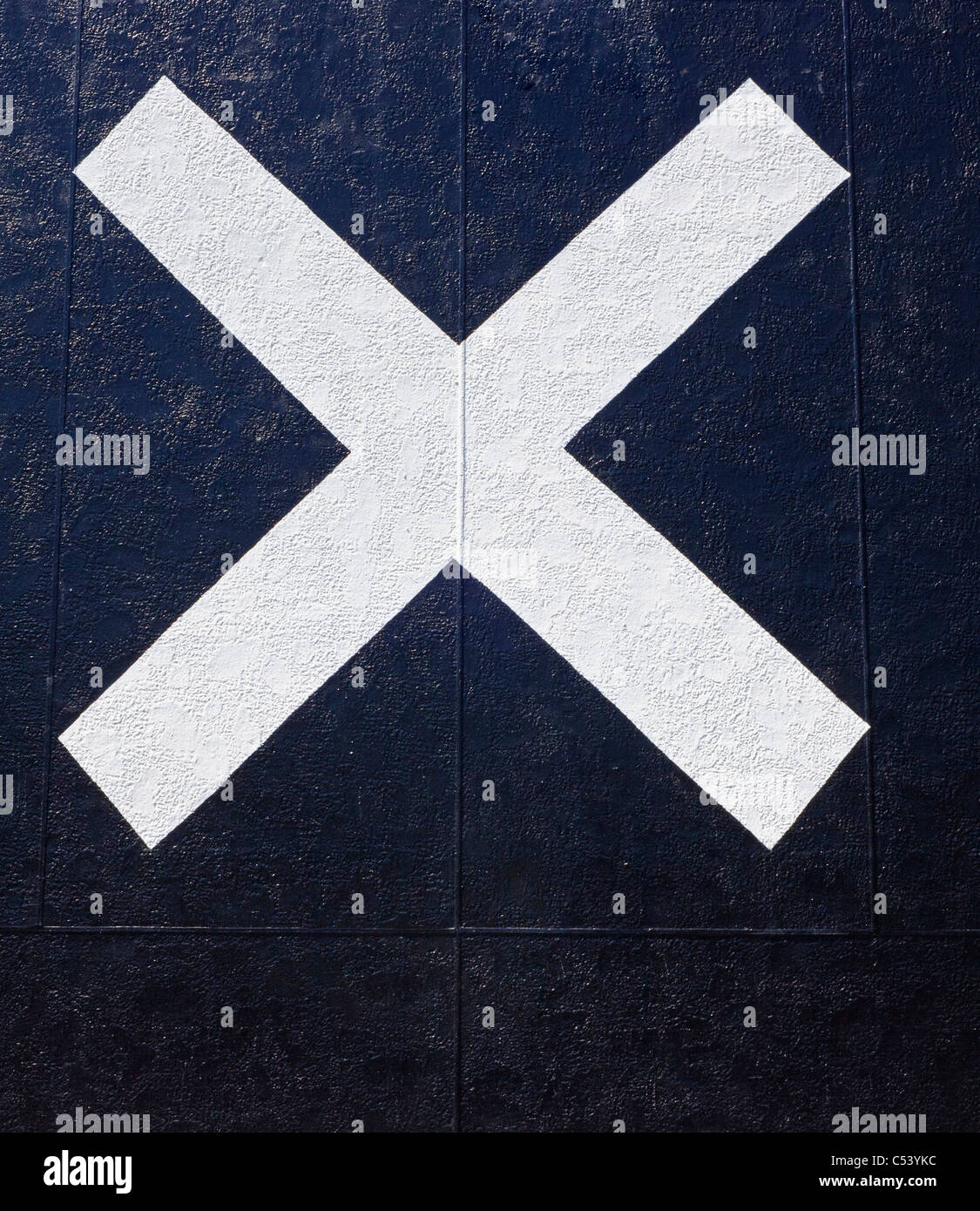 big white X painted on black wall Stock Photo Alamy