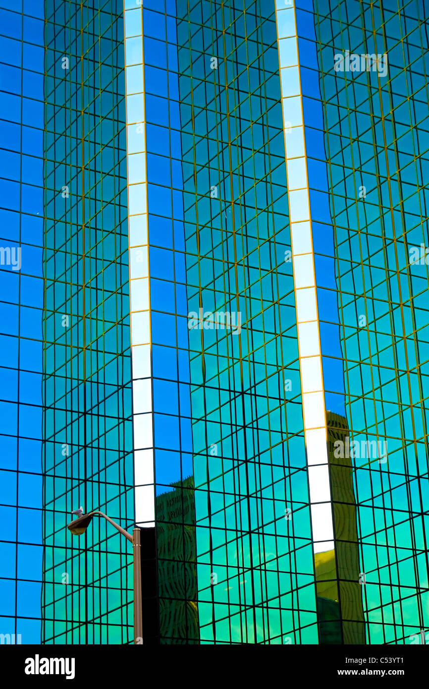 The mirrored facade of a modern office tower. Stock Photo