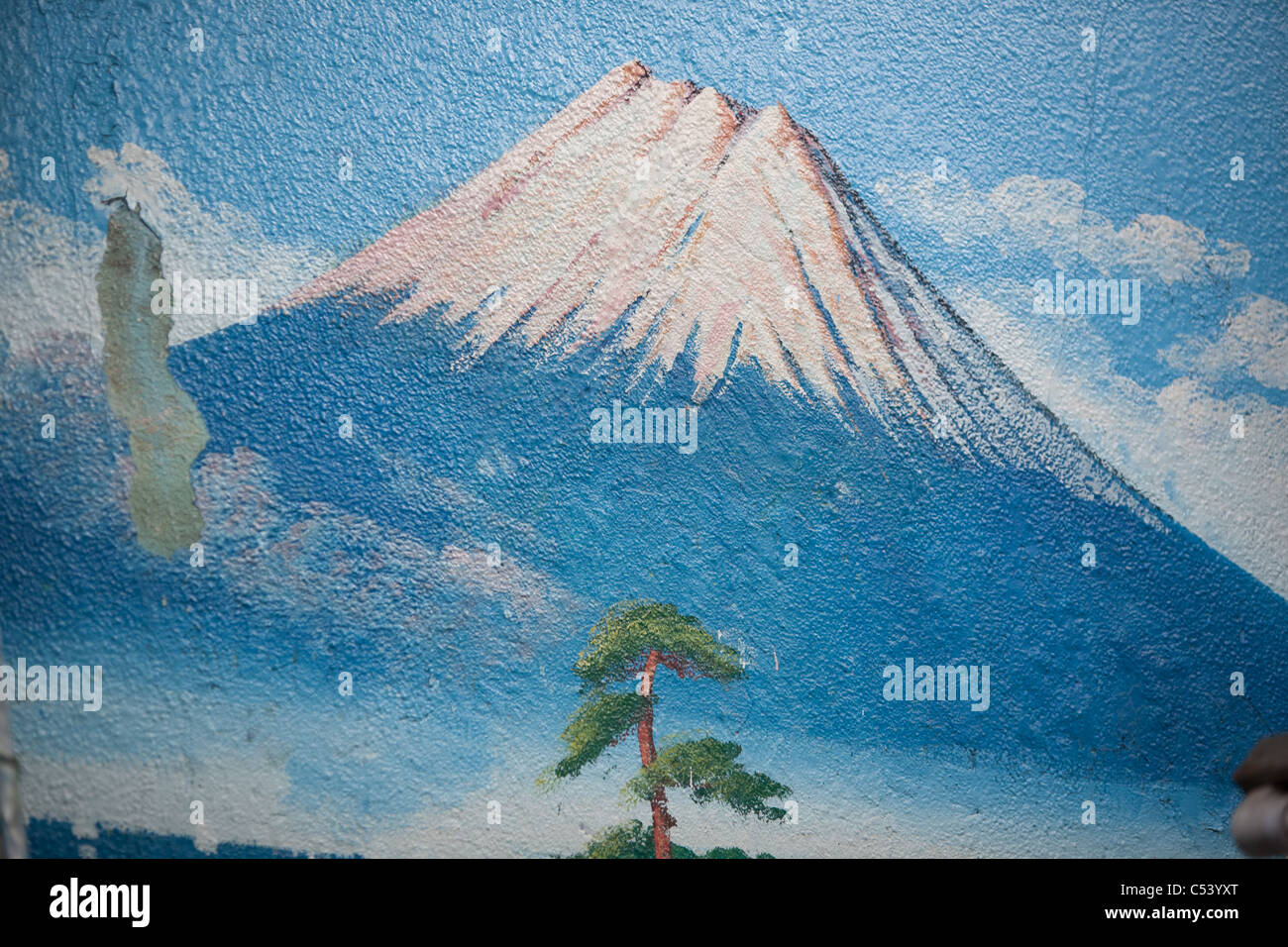 Painting a fresh mural of Mount Fuji over top of older similar view at the  'Moto No Yu' sento (public bath house) in Tokyo Stock Photo - Alamy