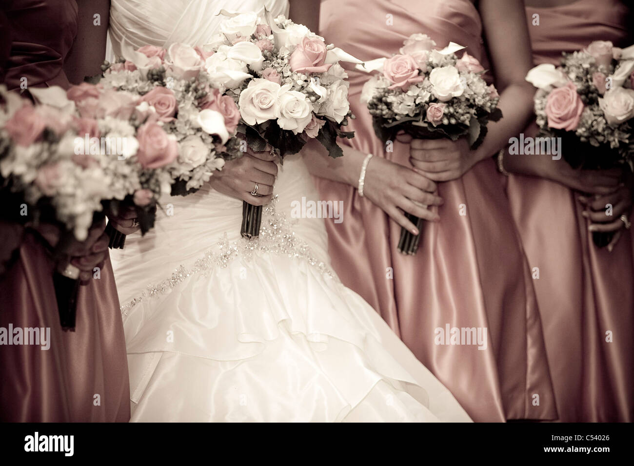 bride and bridesmaids holding flowers during wedding portraits Stock ...