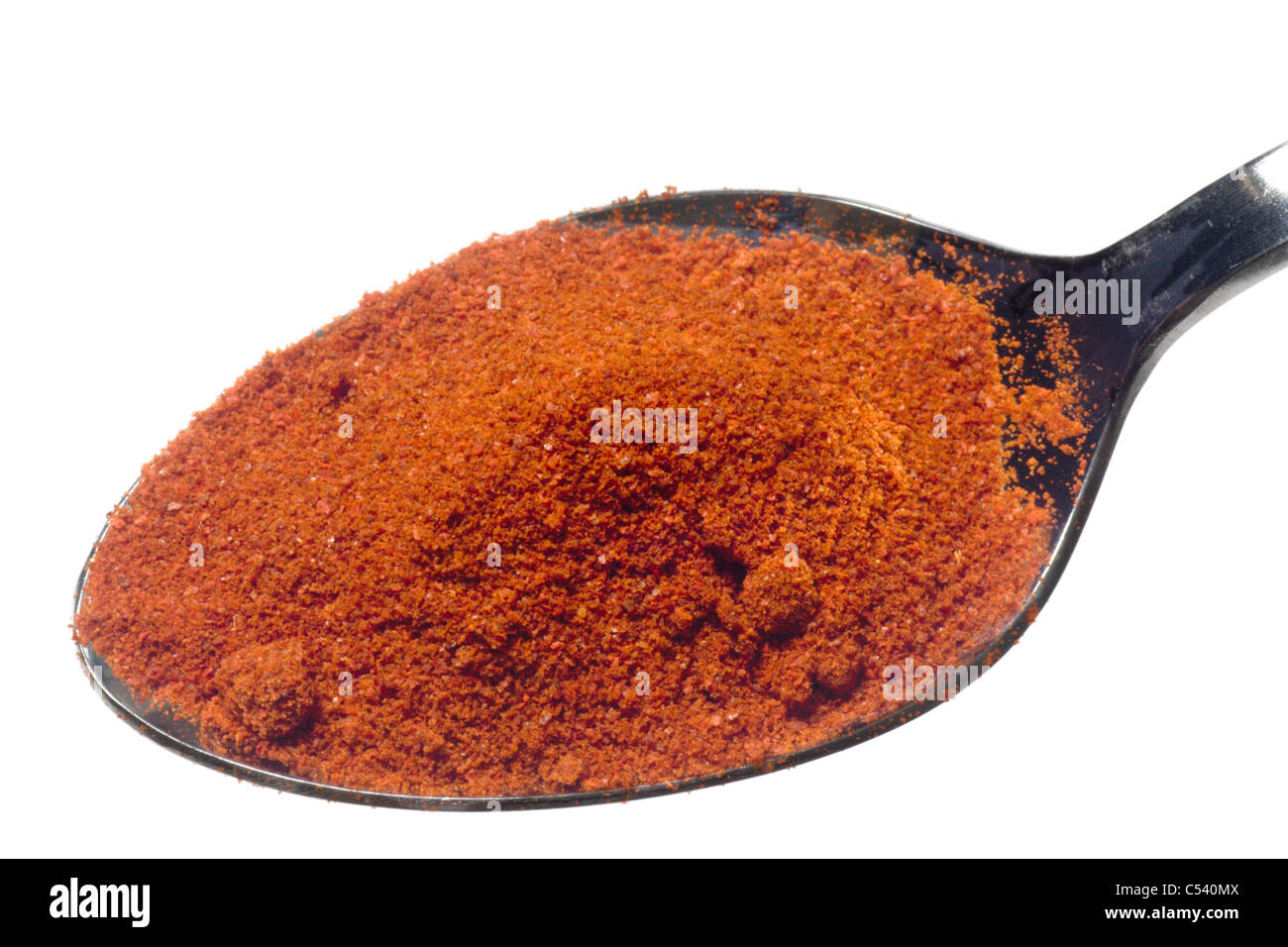 Spoonful of ground chilli powder isolated on white background Stock Photo