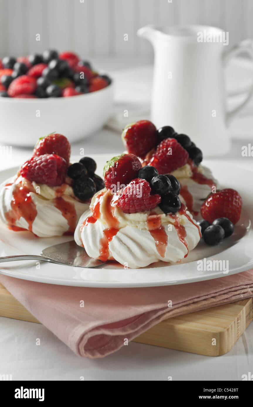 Meringue nests with fruit and cream Stock Photo Alamy