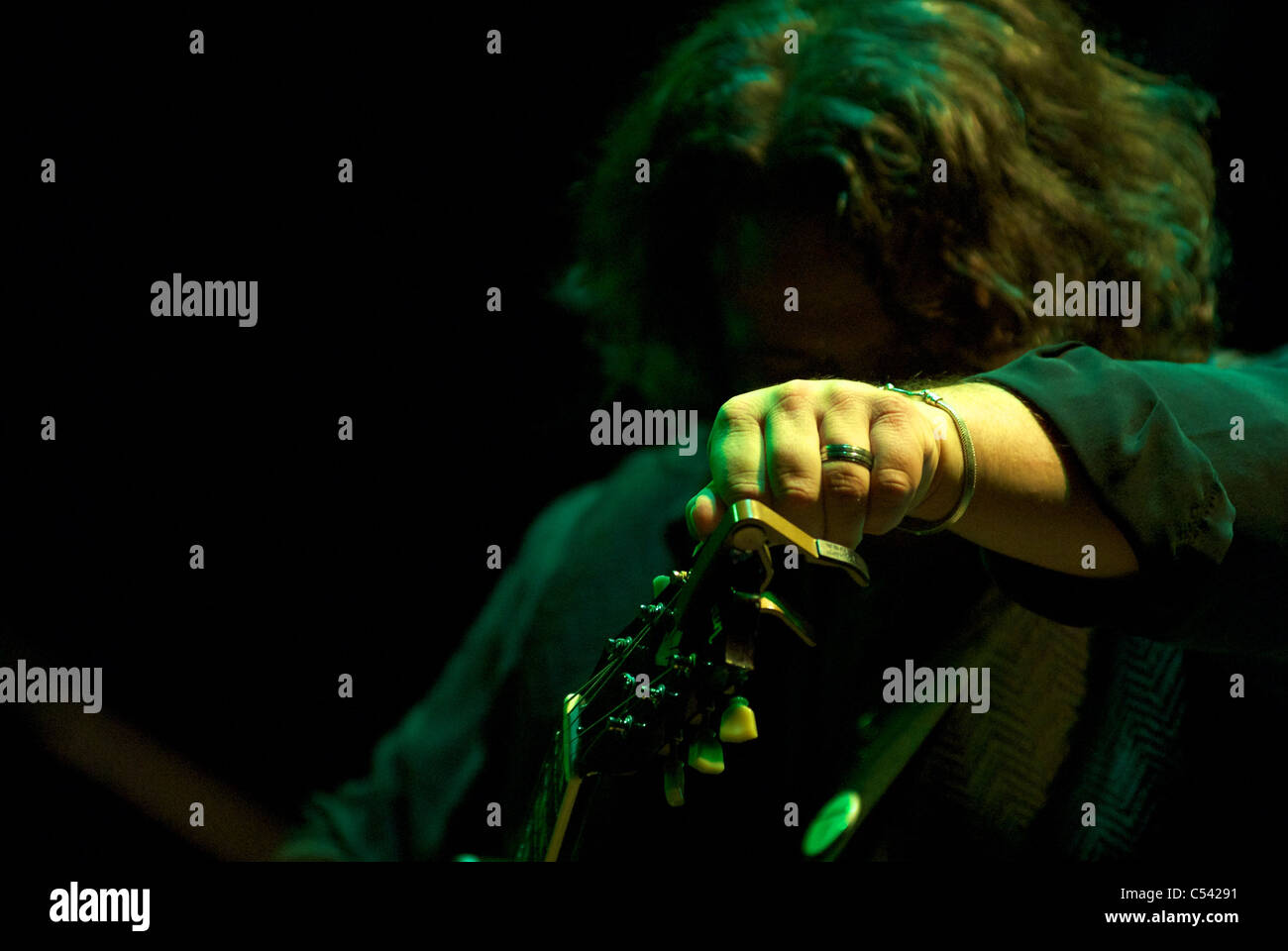 fine tuning the acoustic guitar during a concert Stock Photo Alamy