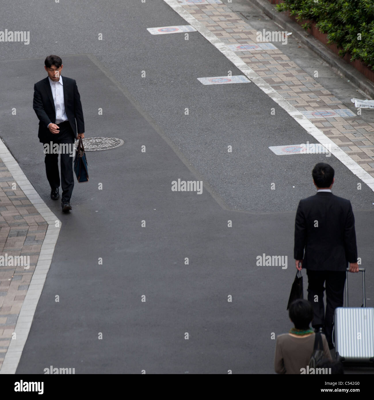 Businessmen walking on a walkway, Tokyo, Japan Stock Photo - Alamy