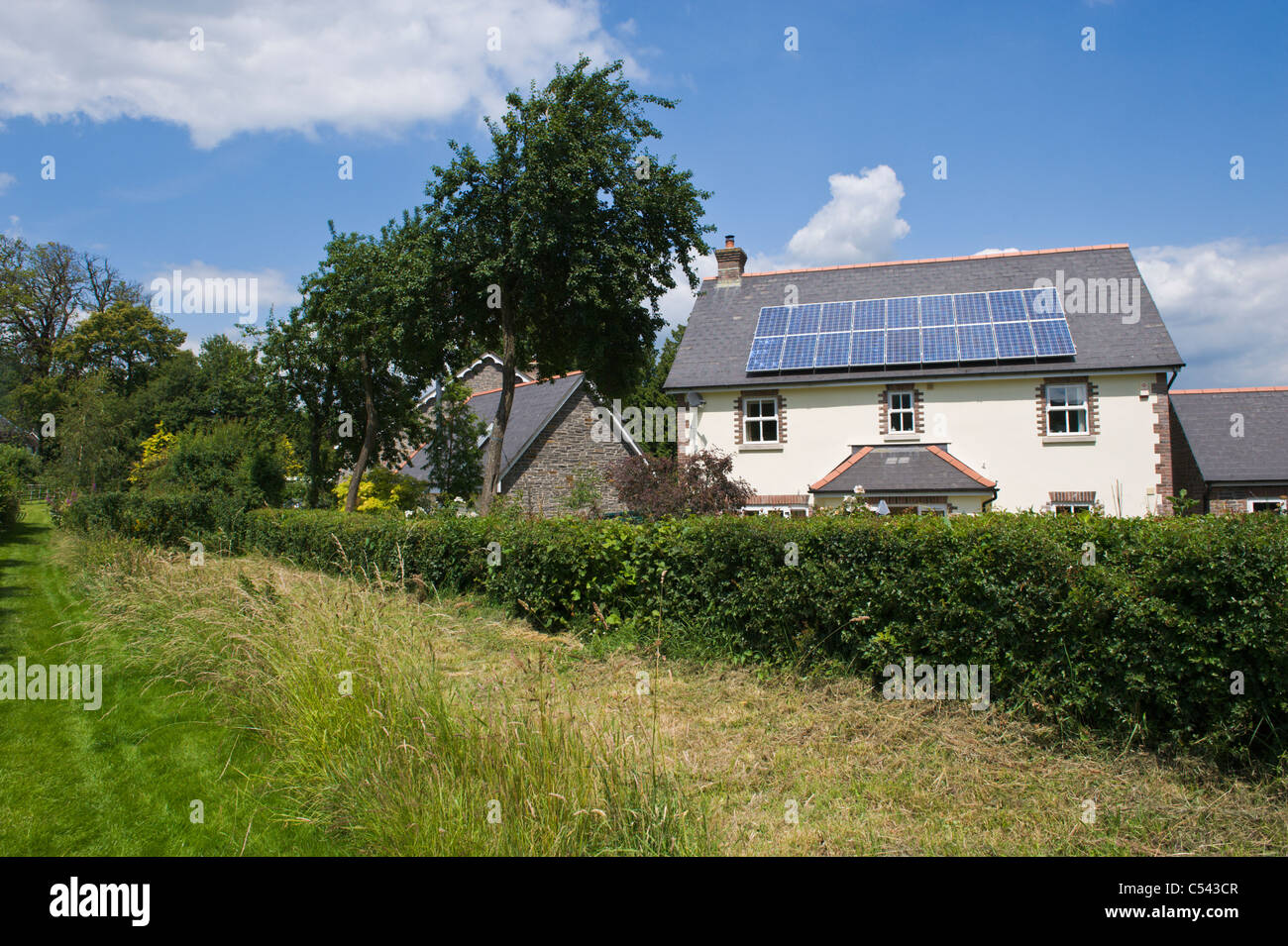 solar panels house UK. Solar panels on roof of detached house in