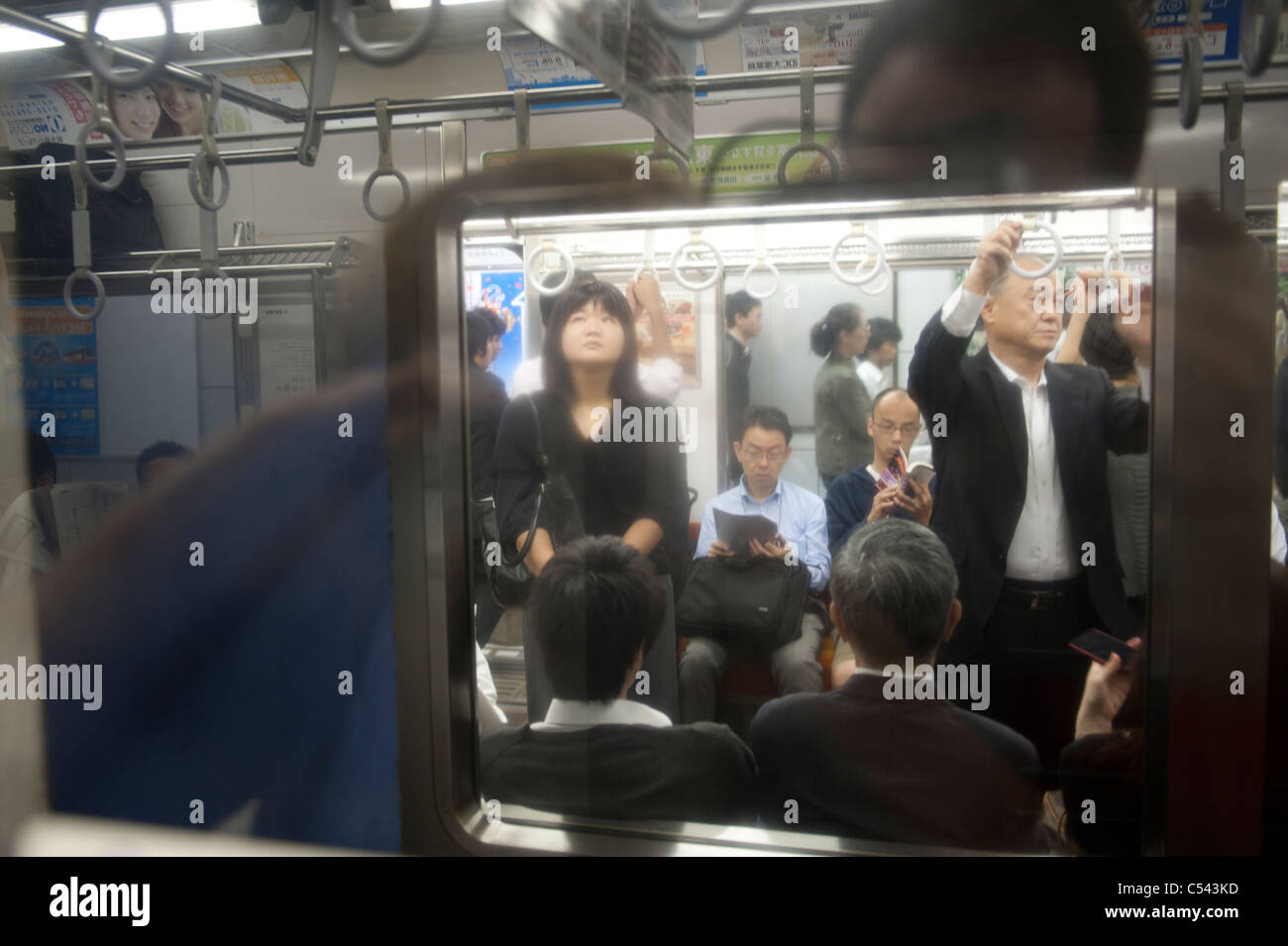 Passengers traveling in a subway train, Tokyo, Japan Stock Photo