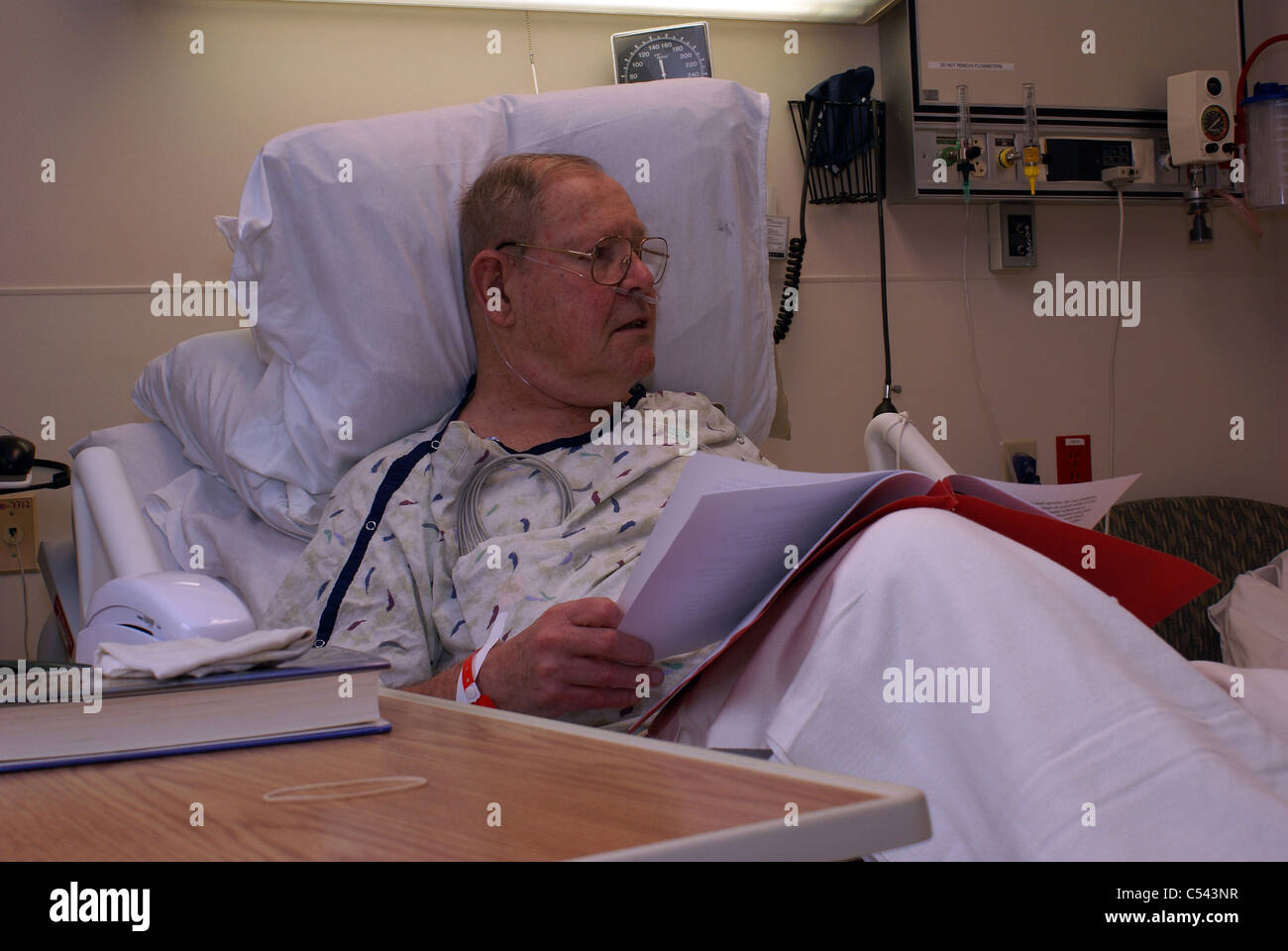 Hospital patient reading information in hospital bed Stock Photo Alamy
