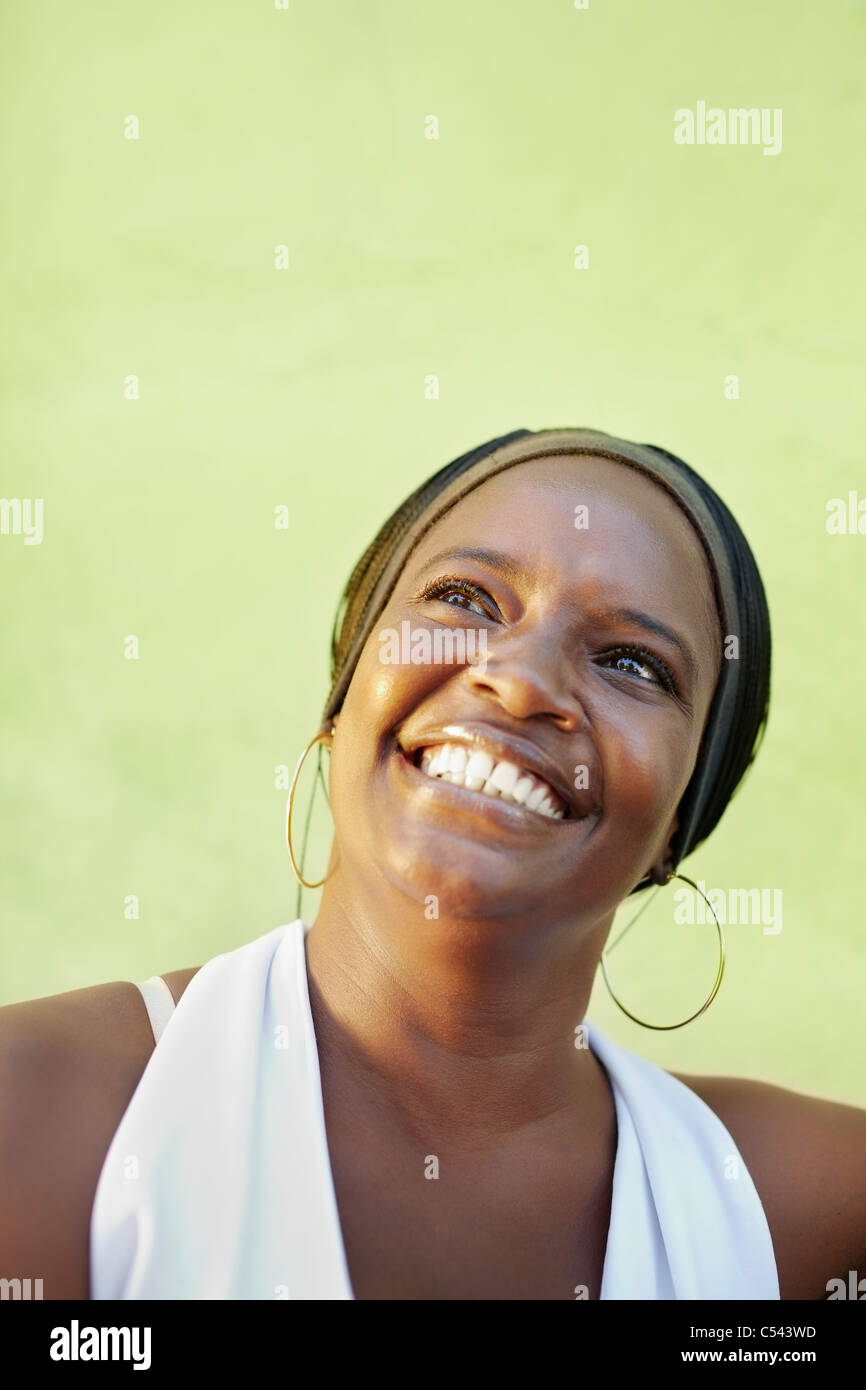 portrait of happy african adult woman looking up and smiling. Vertical shape, copy space Stock Photo
