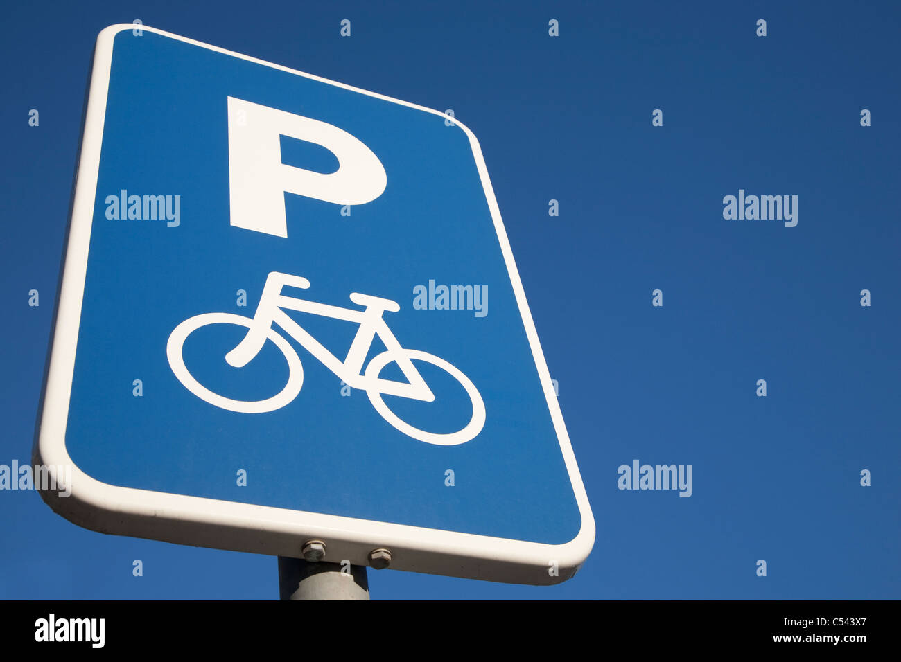 Bike Parking Sign against Blue Sky Background with Copy Space Stock