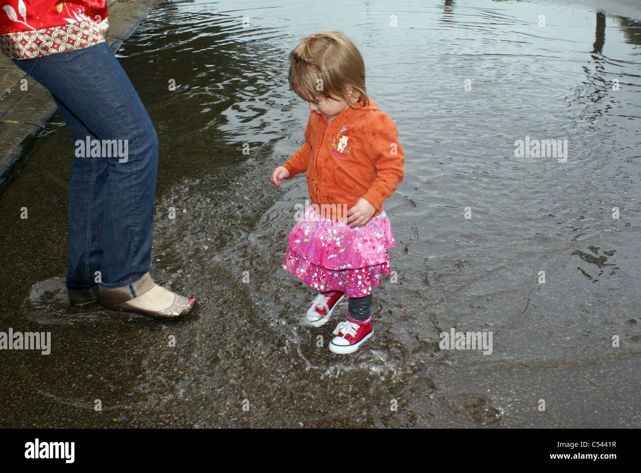 Getting wet in a puddle Stock Photo - Alamy
