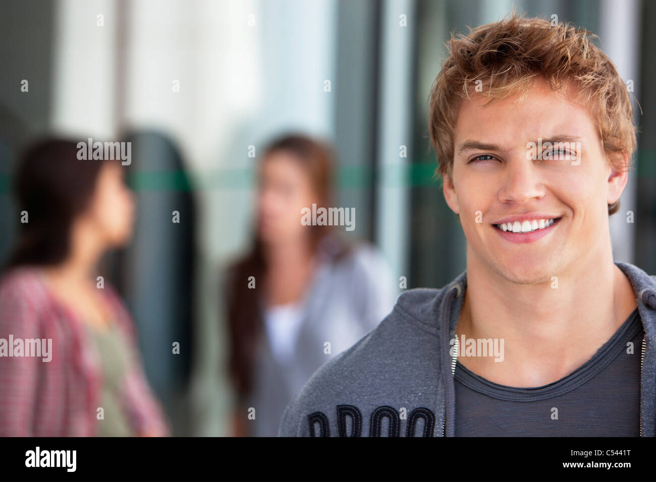 Portrait of a man smiling in a campus Stock Photo - Alamy