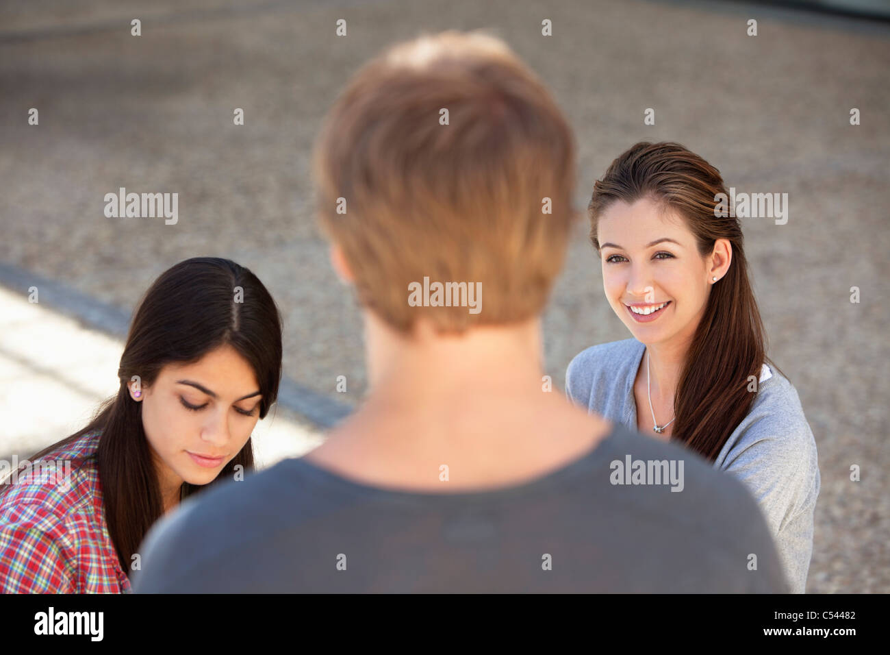 Three friends having discussion Stock Photo - Alamy
