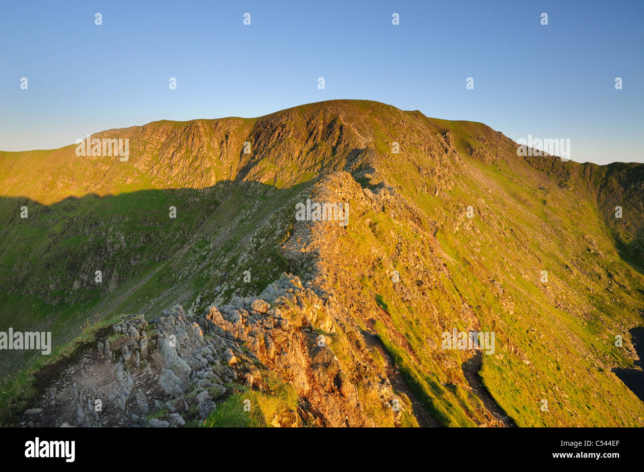 View of a deserted Striding Edge and Helvellyn at dawn in summer in the English Lake District Stock Photo