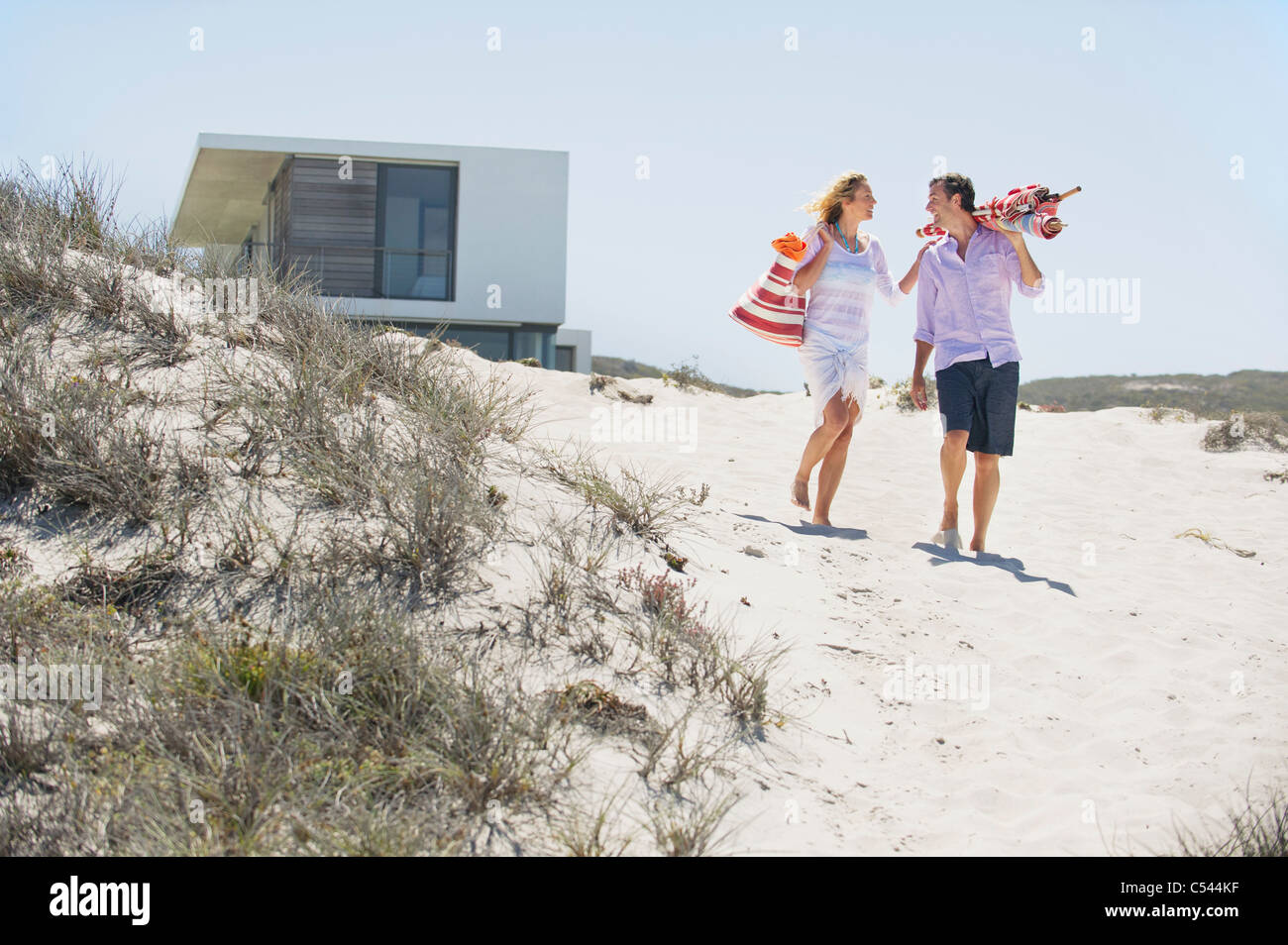 Couple walking on the beach Stock Photo