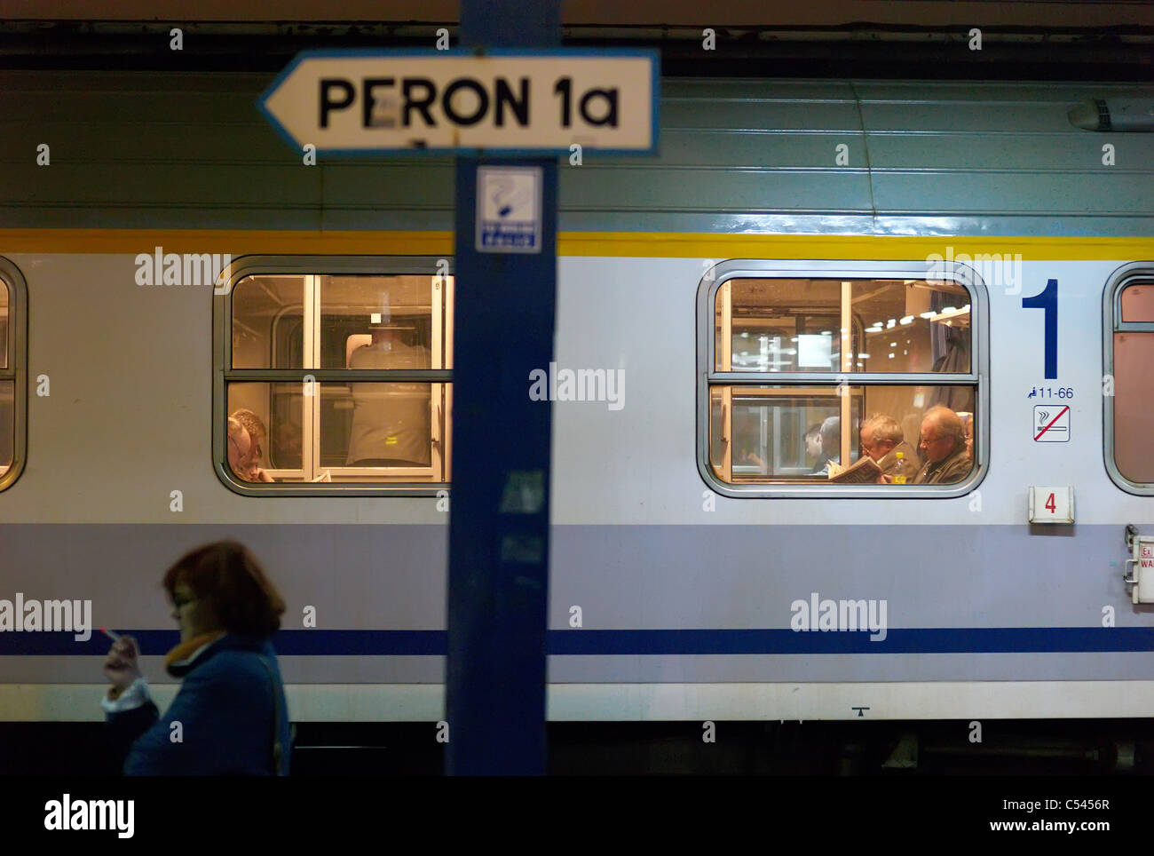 A train and passengers waiting on a platform, Poznan, Poland Stock Photo