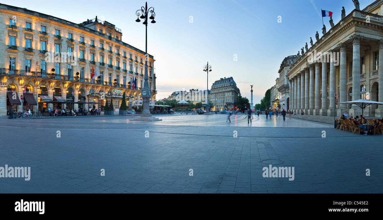 Evening panorama of Bordeaux's Place de la Comédie, with the Regent Grand Hotel on the left and Le Grand Théâtre on the right Stock Photo