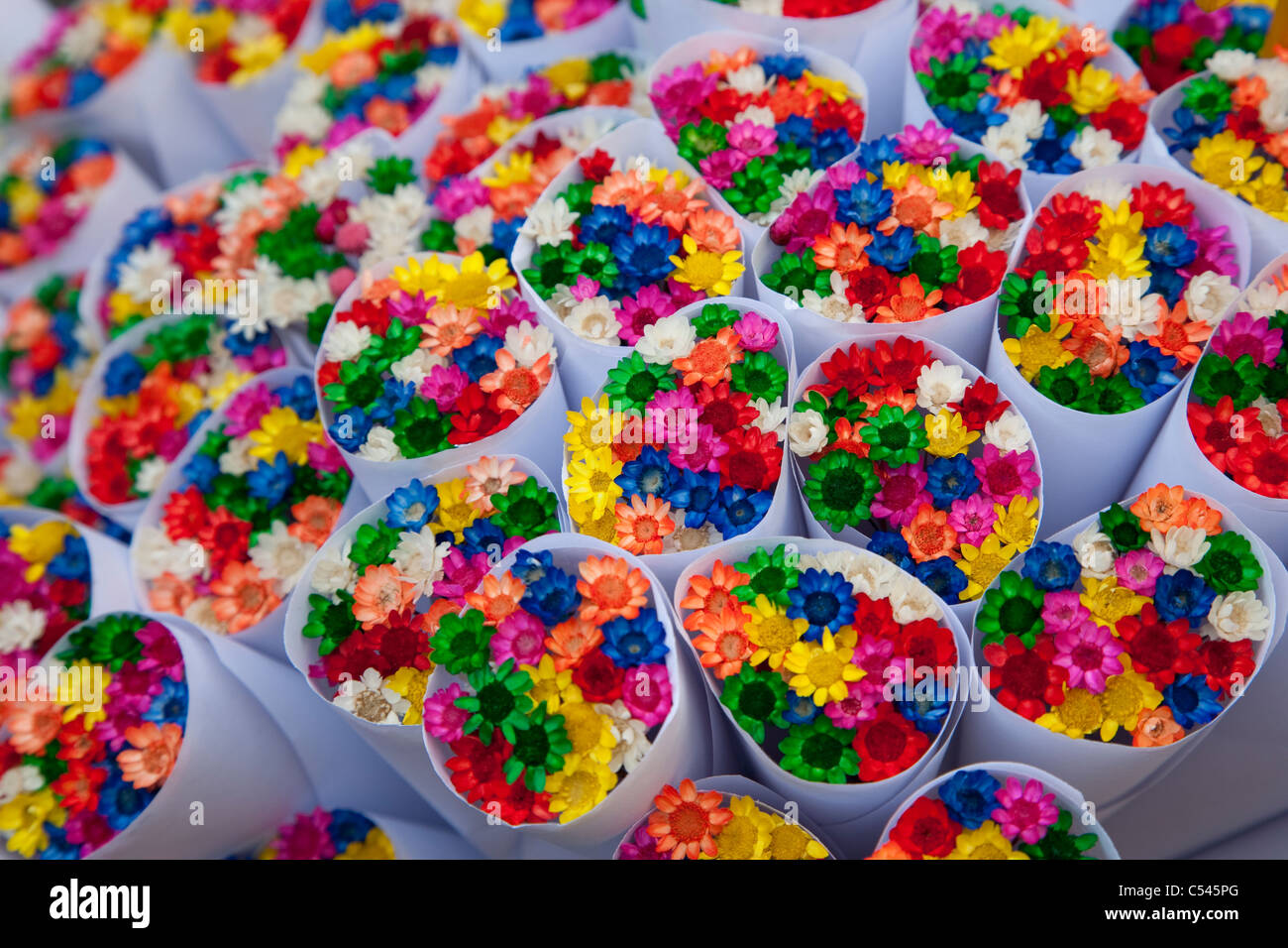 Colorful Small Plastic Flowers on Sale on Market Stall in Barcelona