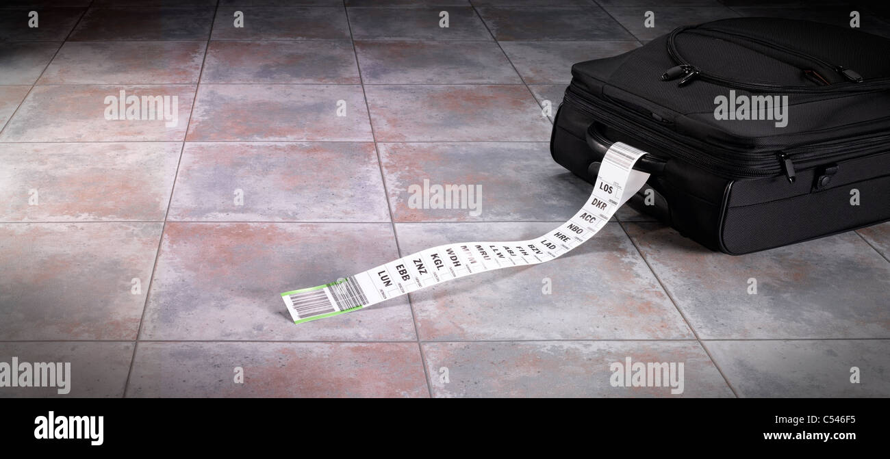 A suitcase with a long luggage tag indicating a frequent flyer Stock Photo