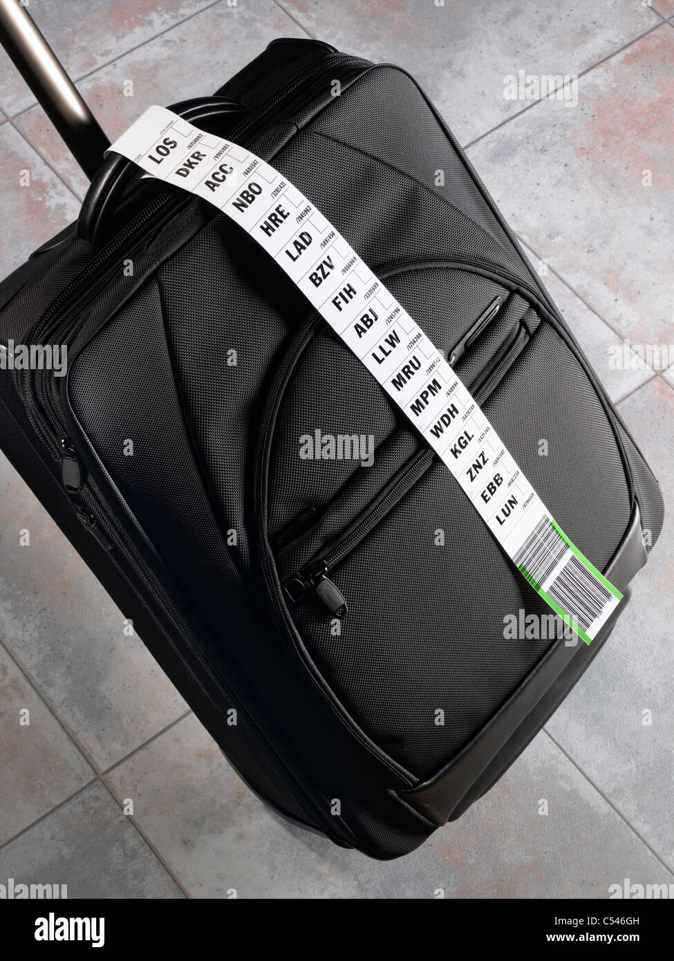 A suitcase with a long luggage tag indicating a frequent flyer Stock Photo