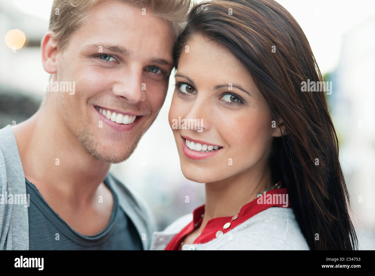 Portrait of a young couple smiling Stock Photo - Alamy