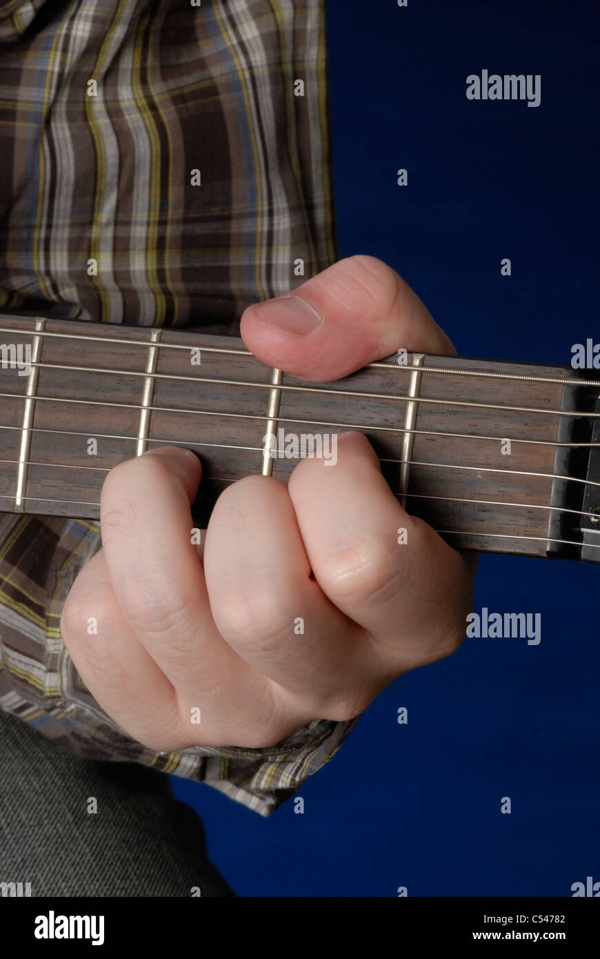 Man's hand demonstrating a D Chord on guitar Stock Photo