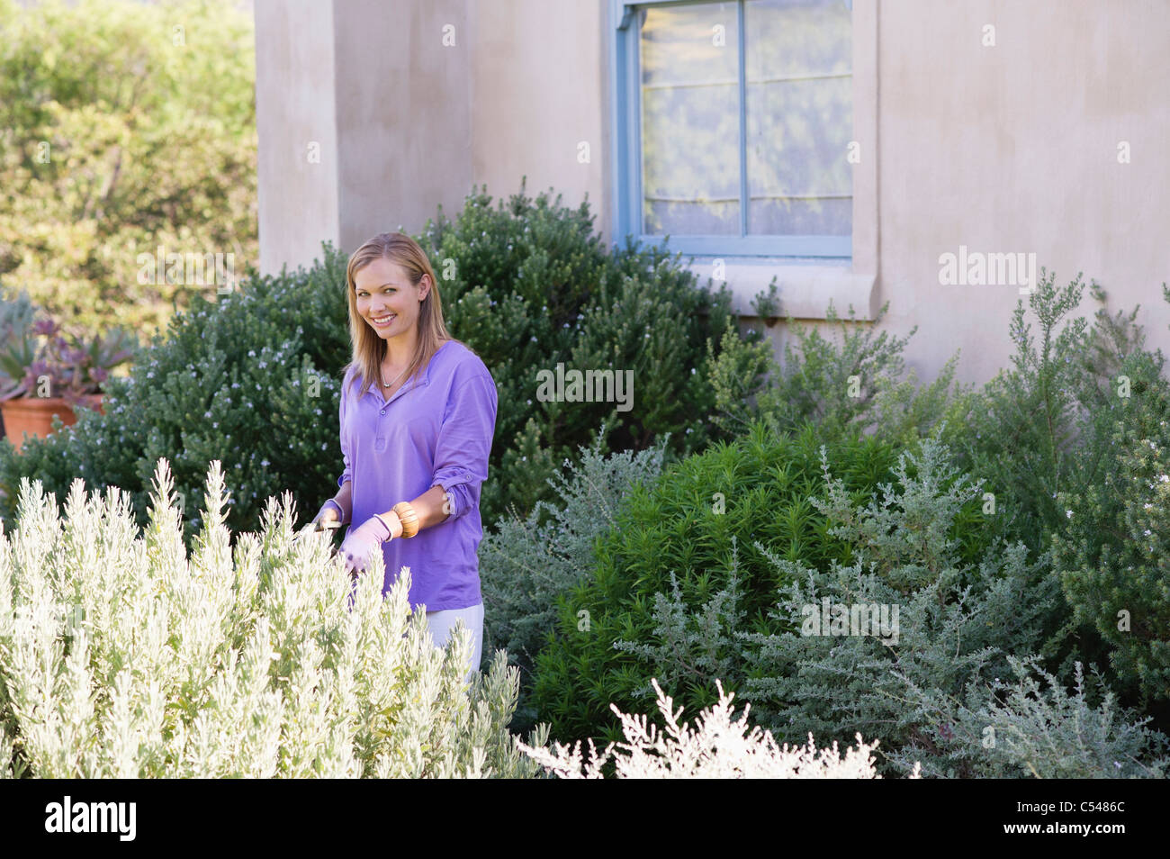 Portrait of a young woman gardening Stock Photo - Alamy