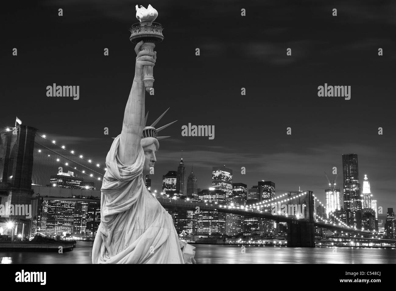 Manhattan Skyline, Brooklyn Bridge and The Statue of Liberty at Night