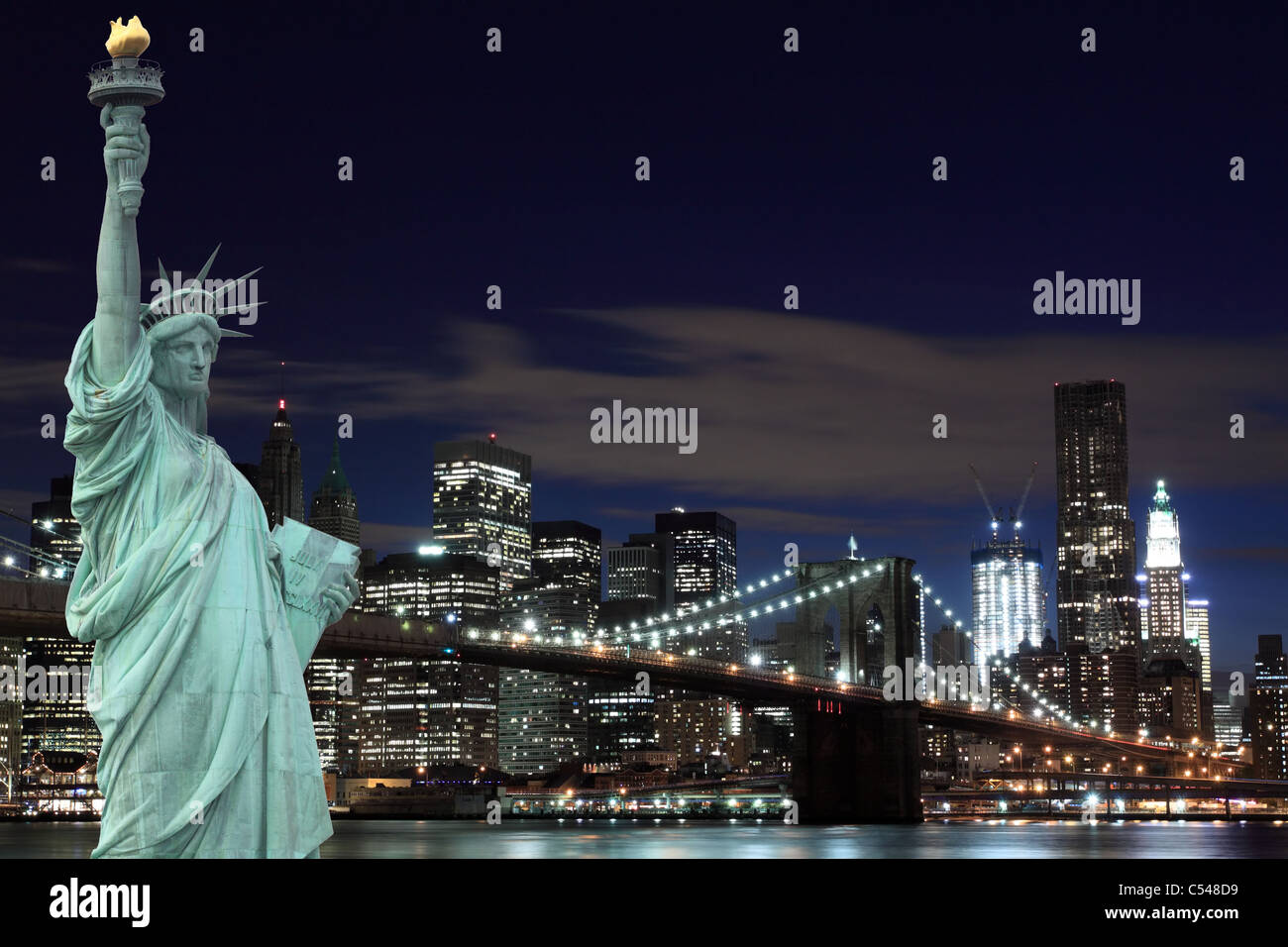 Manhattan Skyline, Brooklyn Bridge and The Statue of Liberty at Night