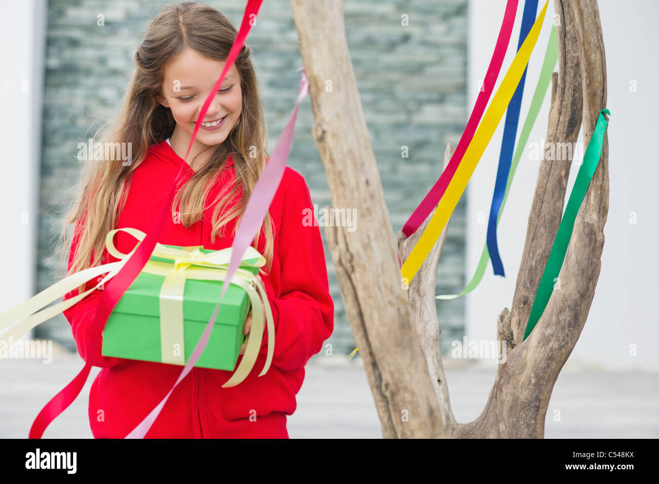 Girl holding a gift box and smiling Stock Photo