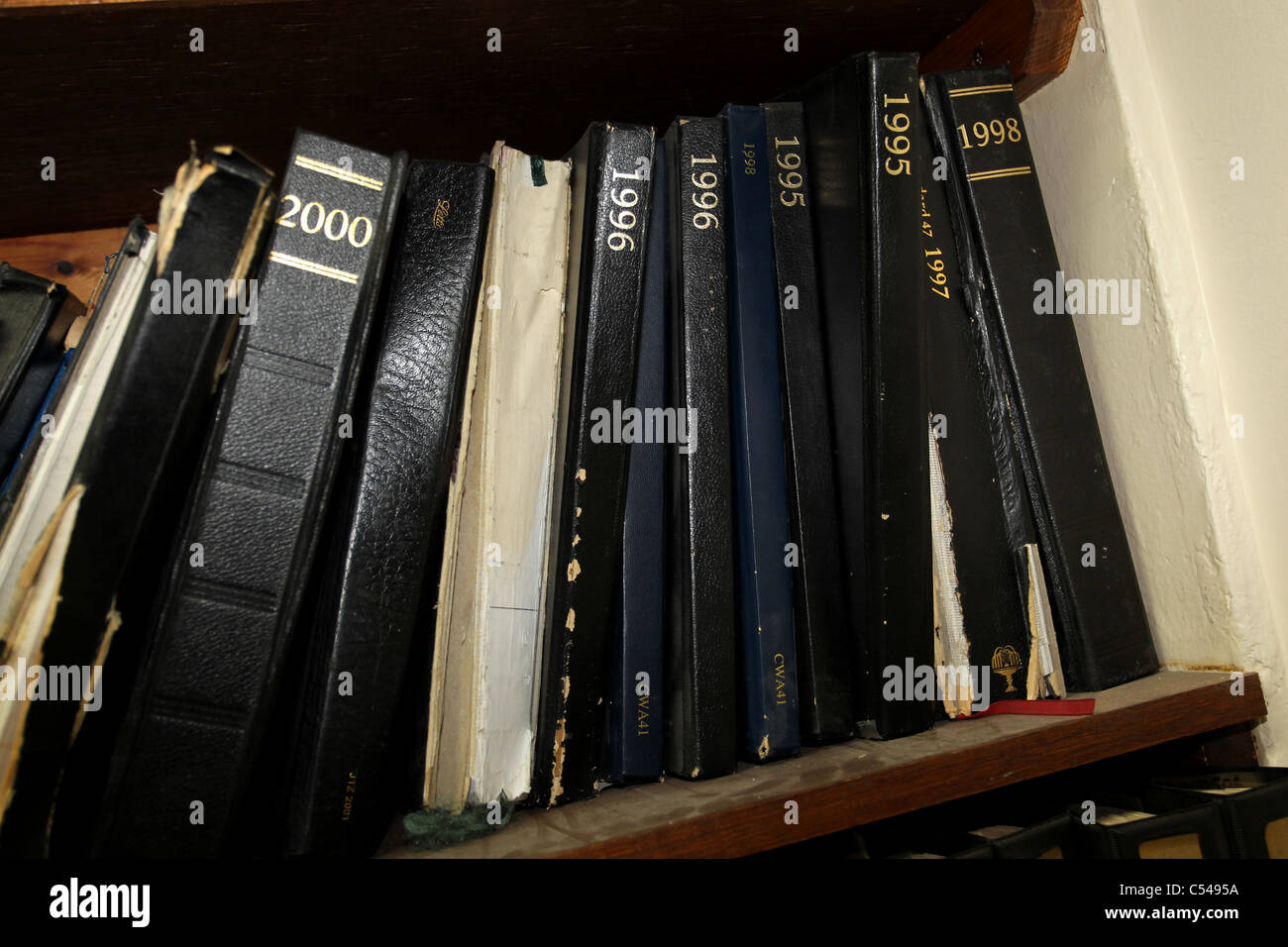 Selection of old diaries on a bookshelf in Hove, East Sussex, UK. Stock Photo