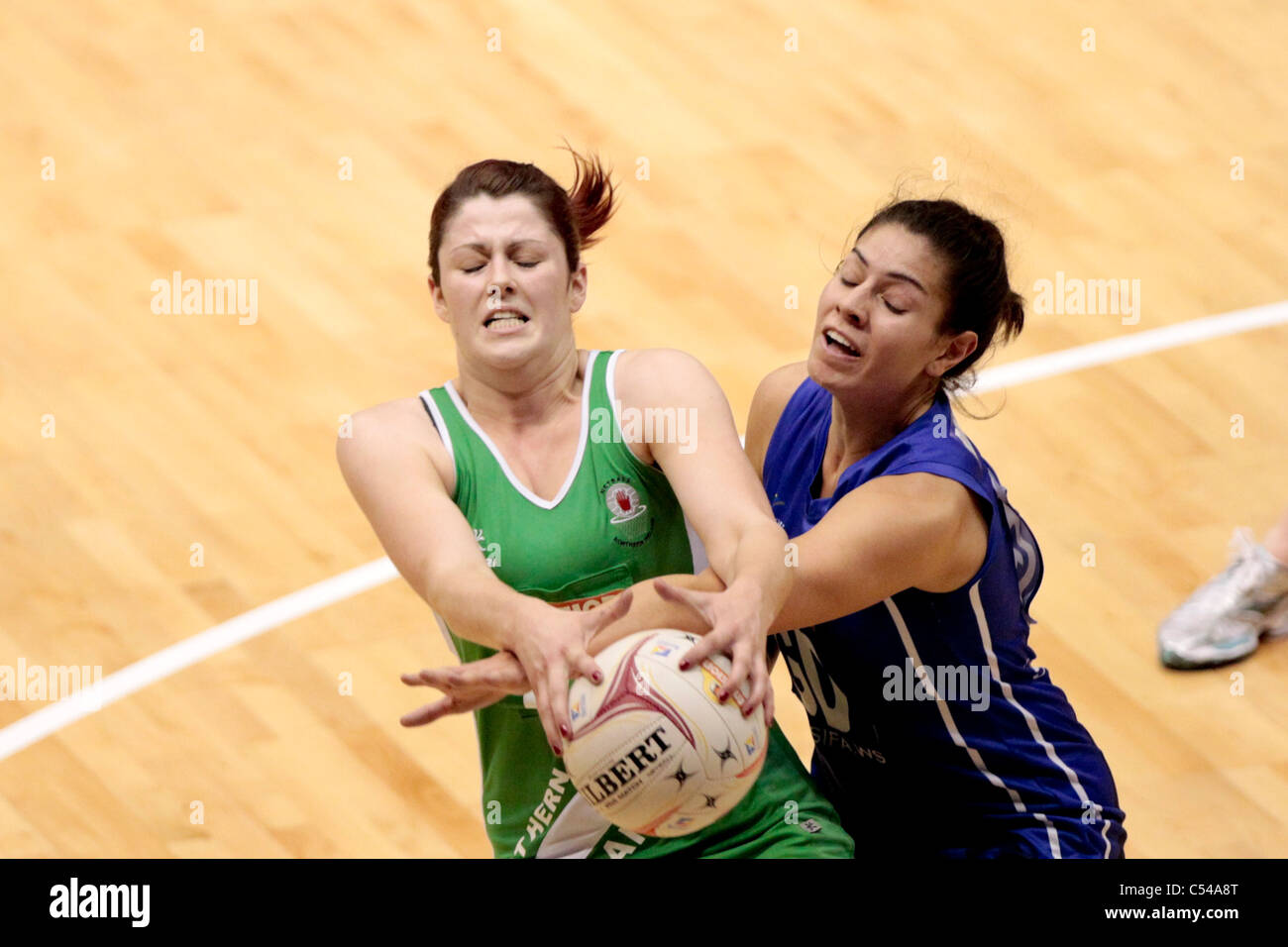06.07.2011 Kyla Bowman of Northern Ireland(left) battles with Sanonu Robertson for the ball during the Pool A match between Northern Ireland VS Samoa, Mission Foods World Netball Championships 2011 from the Singapore Indoor Stadium in Singapore. Stock Photo