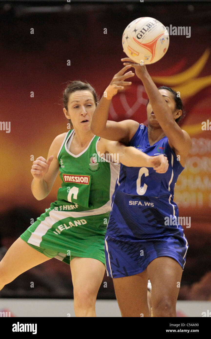 06.07.2011 Caroline O'Hanlon of Northern Ireland(left) battles with Sose Tavae for the ball during the Pool A match between Northern Ireland VS Samoa, Mission Foods World Netball Championships 2011 from the Singapore Indoor Stadium in Singapore. Stock Photo