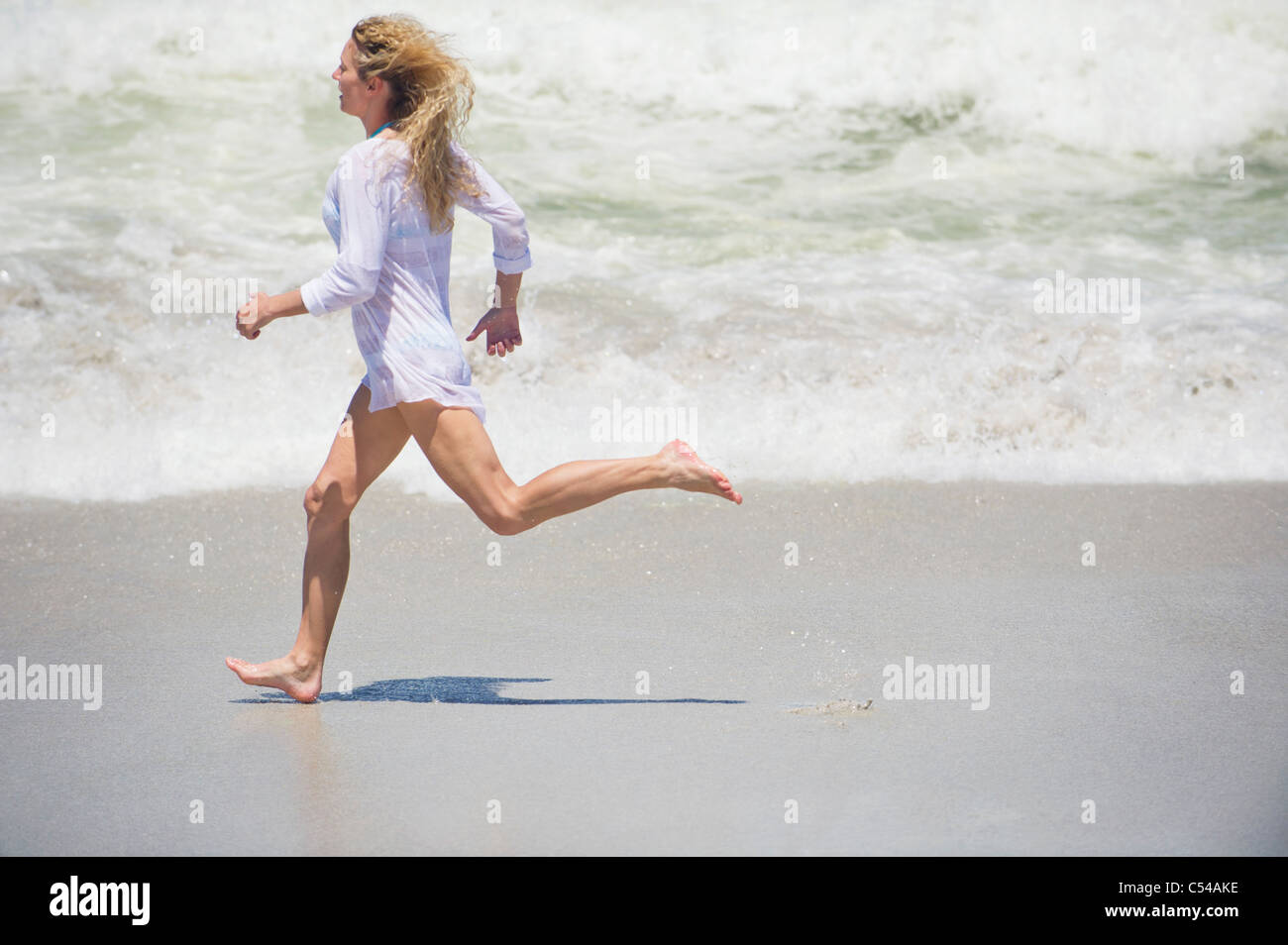 Beach Rode Side Profile Side profile of a beautiful woman running on the beach Stock Photo - Alamy