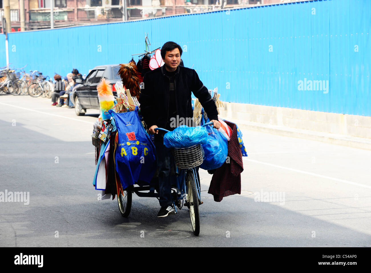 Chinese street trader on his bike in shanghai. Stock Photo