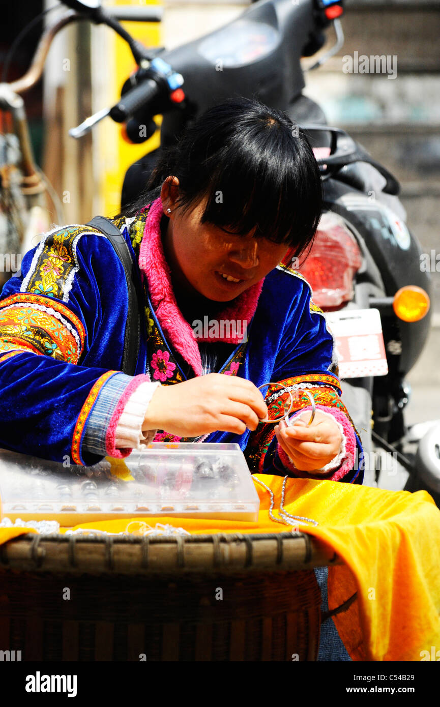 Chinese woman making and selling craft goods in Shanghai old town Stock Photo