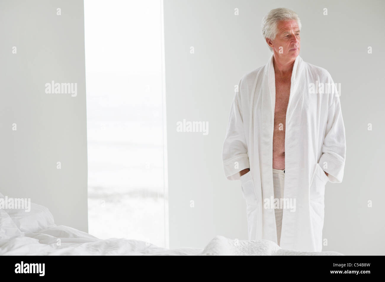 Senior man wearing a bathrobe Stock Photo Alamy