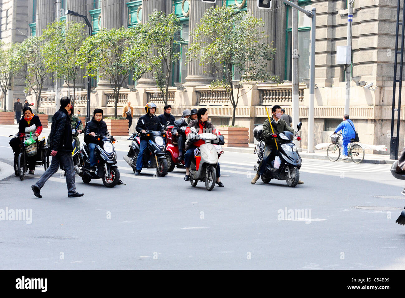 People ridings scooters in Shanghai Stock Photo