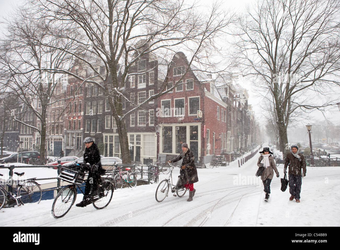The Netherlands, Amsterdam, Winter, snow. Cyclists and pedestrians on