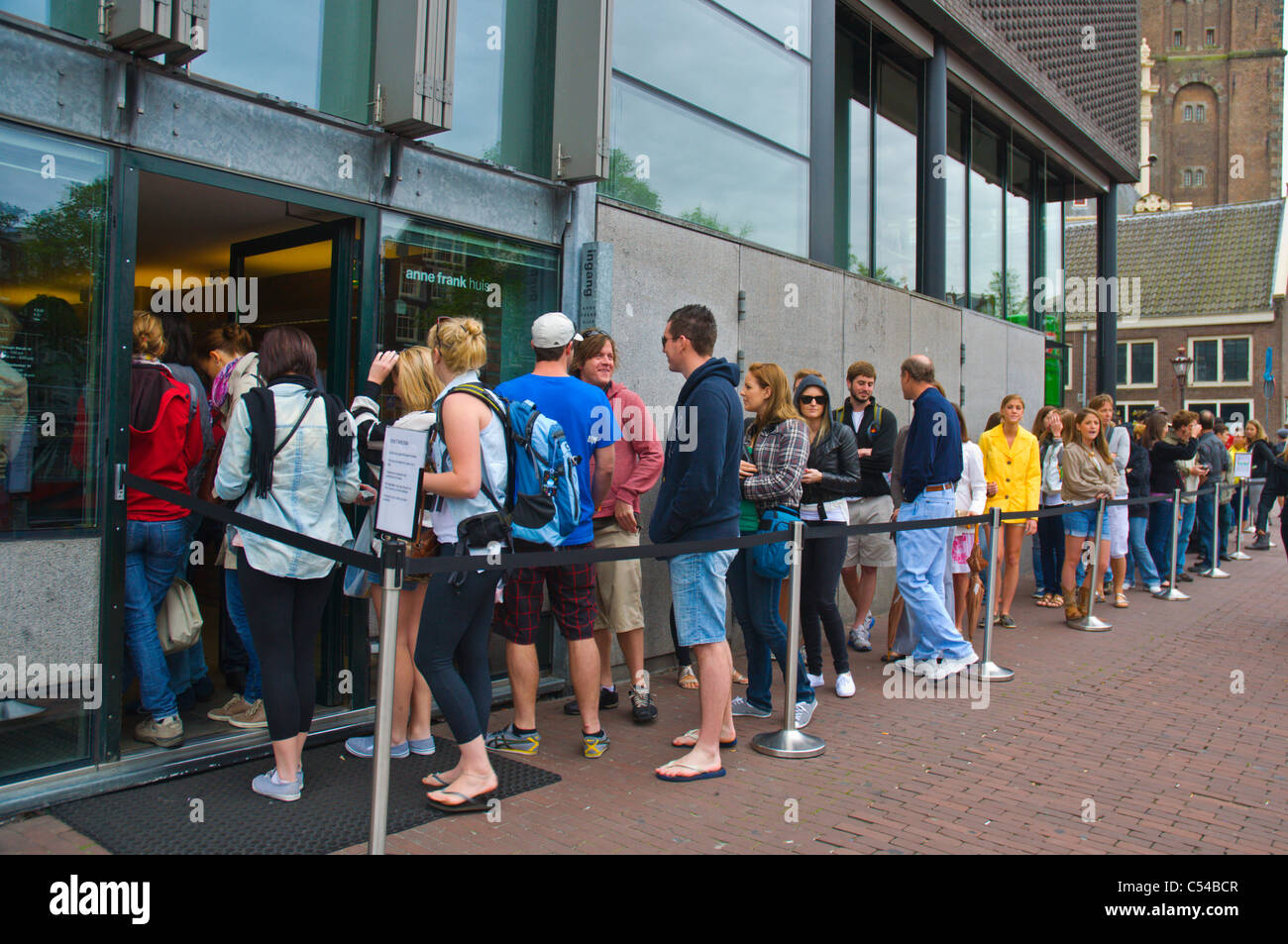 Queue outside Het Anne Frank Huis the Anne Frank House museum central Amsterdam the Netherlands Europe Stock Photo