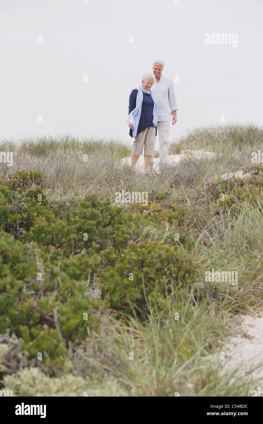 Senior couple walking on the beach Stock Photo - Alamy
