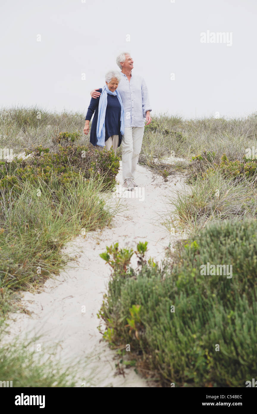 Senior couple walking on the beach Stock Photo - Alamy