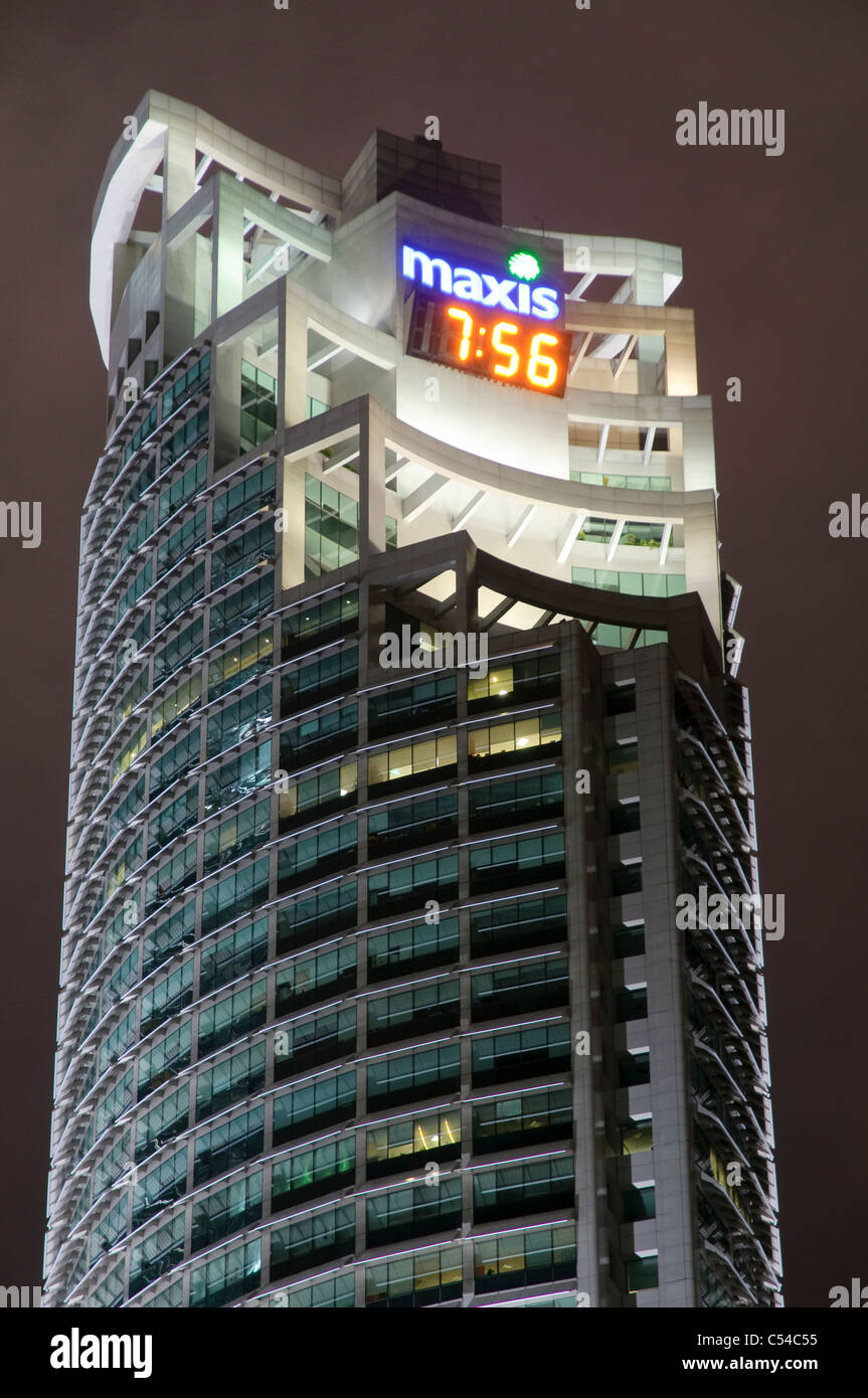 Office building with a digital clock illuminated at night, Kuala Lumpur, Malaysia, Southeast Asia, Asia Stock Photo