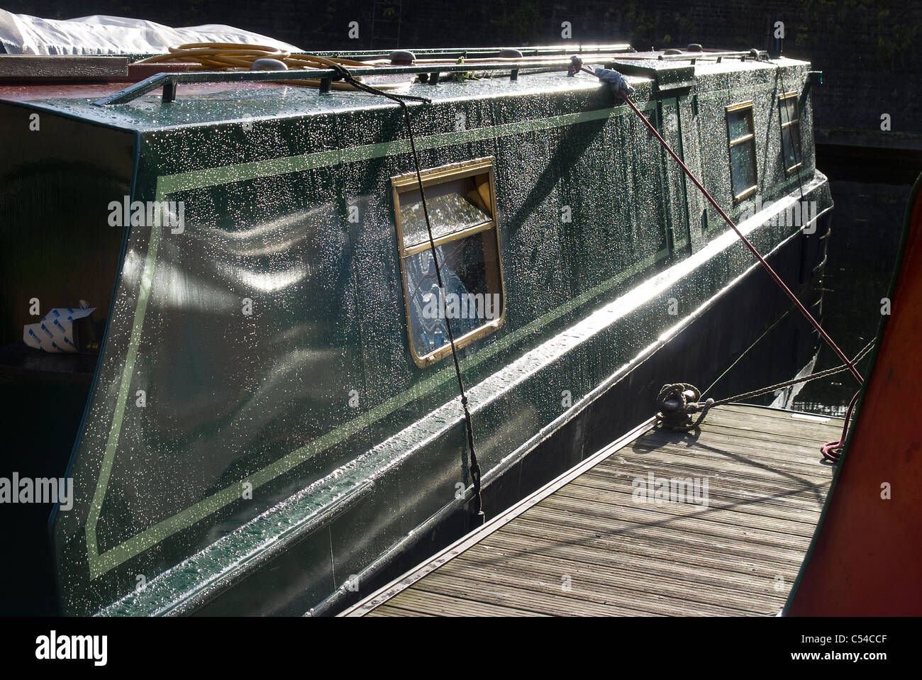 Narrowboat with raindrops from recent shower catching the light, Regent