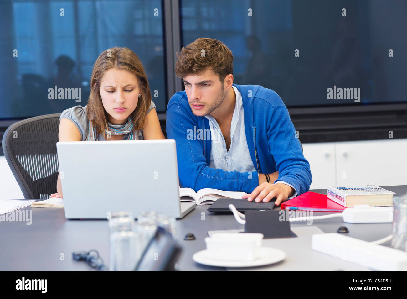University students using laptop in classroom Stock Photo
